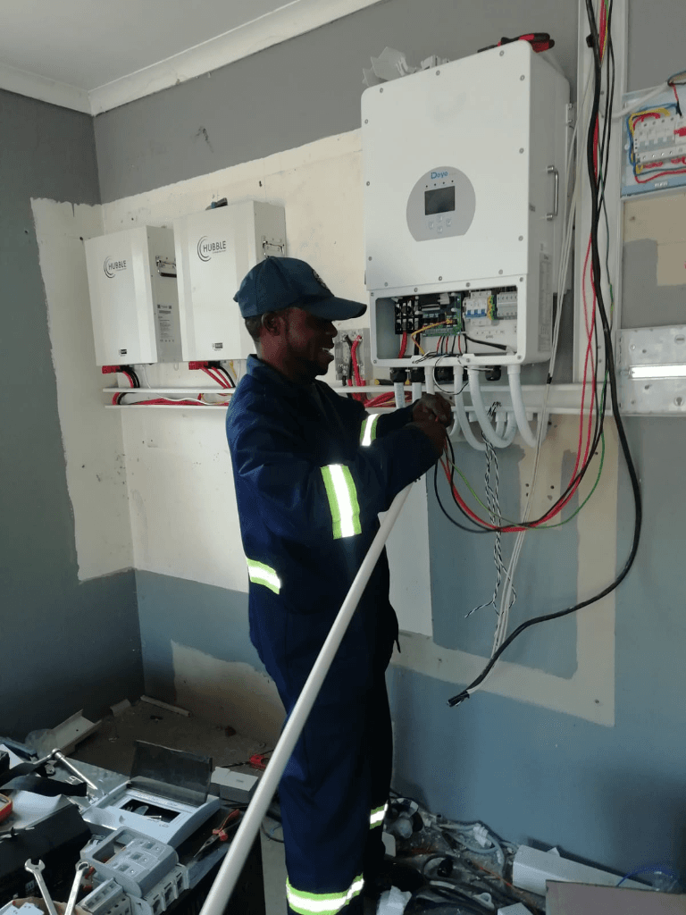 John Ibala in action wiring Deye solar inverter and Hubble lithium battery system